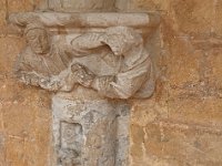 Sculpture sur pilier (deux personnage se disputant une volaille)